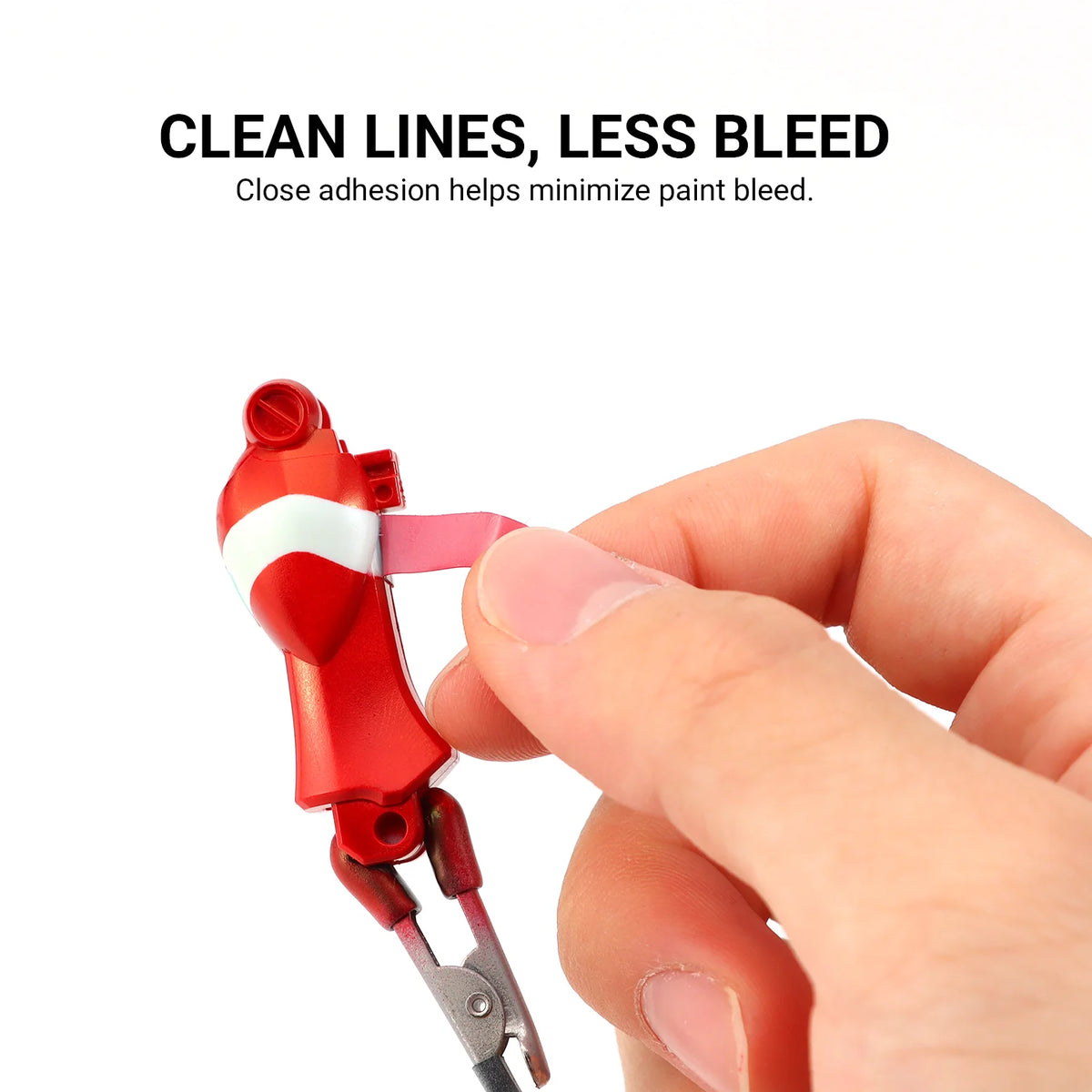 Masking tape lifted from a red model part to demonstrate a sharp painted color boundary