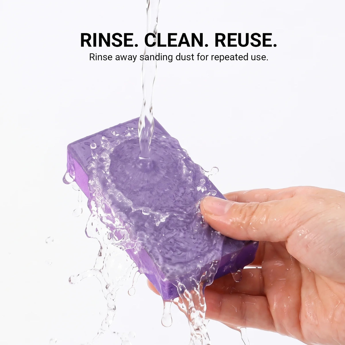 Purple polishing sponge block being rinsed with water to remove sanding dust
