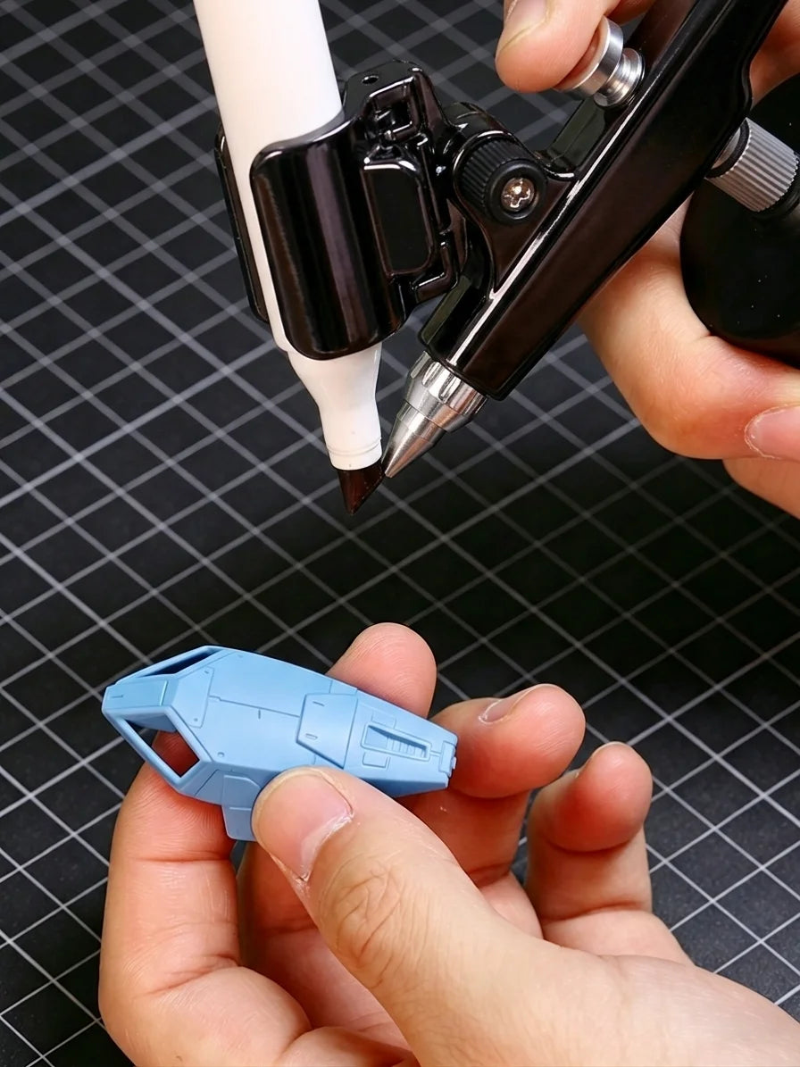 Using a cordless marker airbrush to shade a blue Gunpla armor part