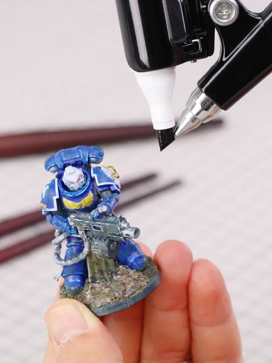 Using a cordless marker airbrush to shade a blue Warhammer miniature